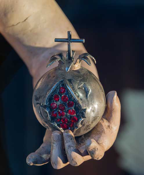 Detail of a jewel of pomegranate, in the hand of a statue of Jesus as child, Granada, Spain - photo by Jebulon